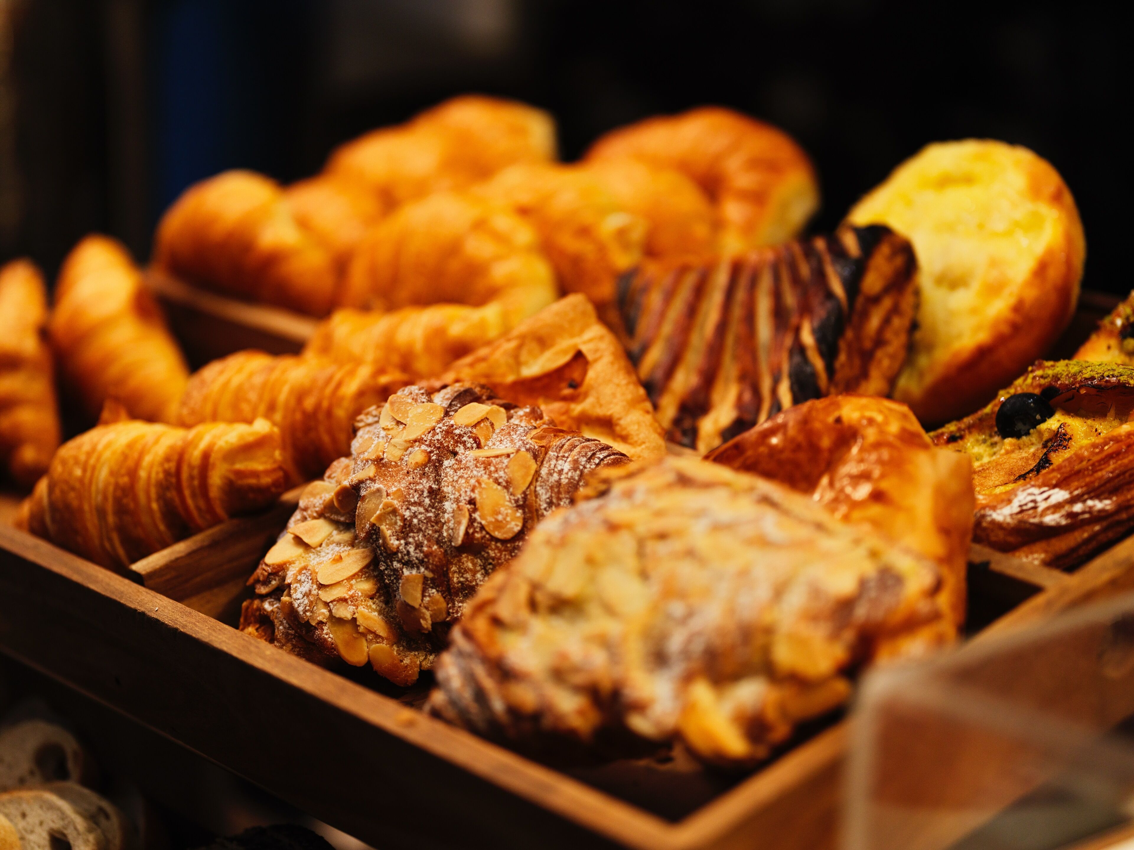 A variety of baked goods displayed in a wooden tray.