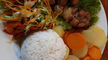 A plate of food with rice, vegetables, and meat.