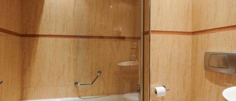 A bathroom with a glass-enclosed shower, a bathtub, and a toilet.