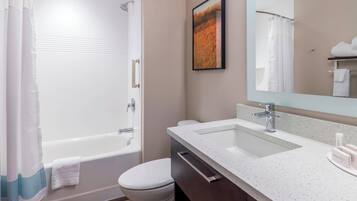 A modern bathroom with a bathtub, toilet, and sink.