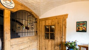 A wooden door with a window, a metal gate, and a sign above it. - Pension Gasthof Etzerschlössl (Berchtesgaden)