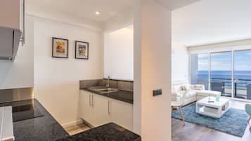 Apartamento panorâmico, 1 quarto, varanda coberta, vista para o mar | Área de estar | TV de tela plana