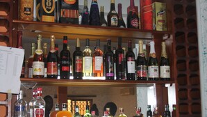 A bar with various liquor bottles, including whiskey, vodka, and wine. - Ruby Kay Hotel (Accra)