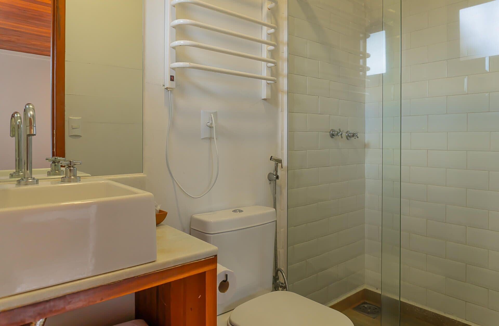 A bathroom with a white sink, toilet, and shower.