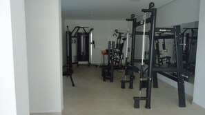 A gym with various exercise equipment, including weight machines and free weights.