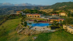 Una extensa propiedad con varias casas, una piscina y un césped bien cuidado.