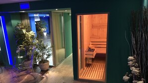 Un hall d’hôtel avec un sauna en bois, des plantes en pot et un escalier.