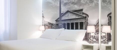 A hotel room with a large bed, two bedside tables with lamps, a large mirror, and a wall mural of a building.