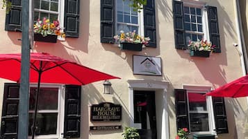 A building with black shutters, flower boxes, and a sign for 'Hargrove House Bed & Breakfast'.