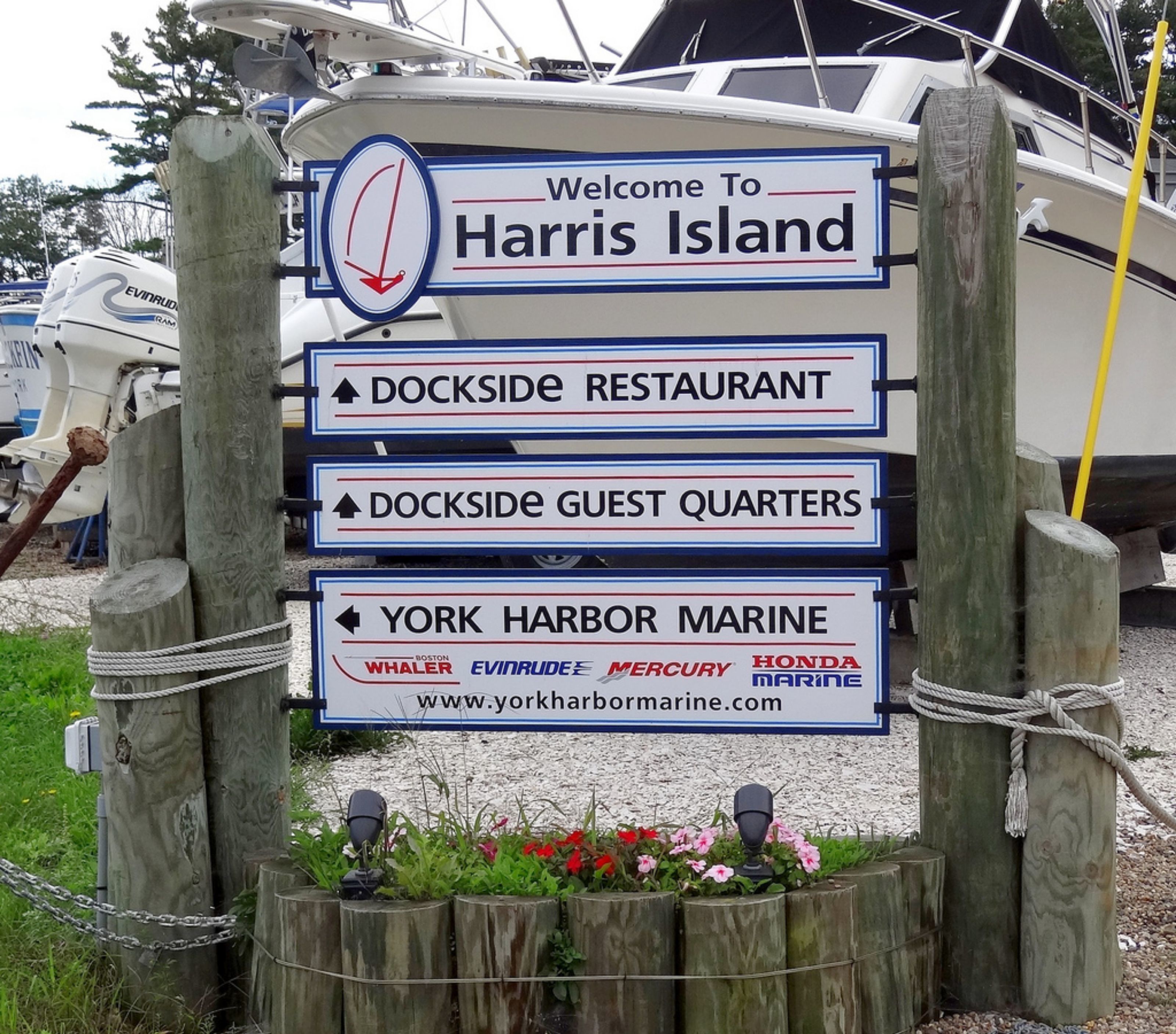 A signpost with directions to Harris Island, Dockside Restaurant, Dockside Guest Quarters, and York Harbor Marine.