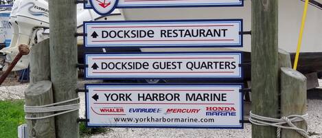 A signpost with directions to Harris Island, Dockside Restaurant, Dockside Guest Quarters, and York Harbor Marine.