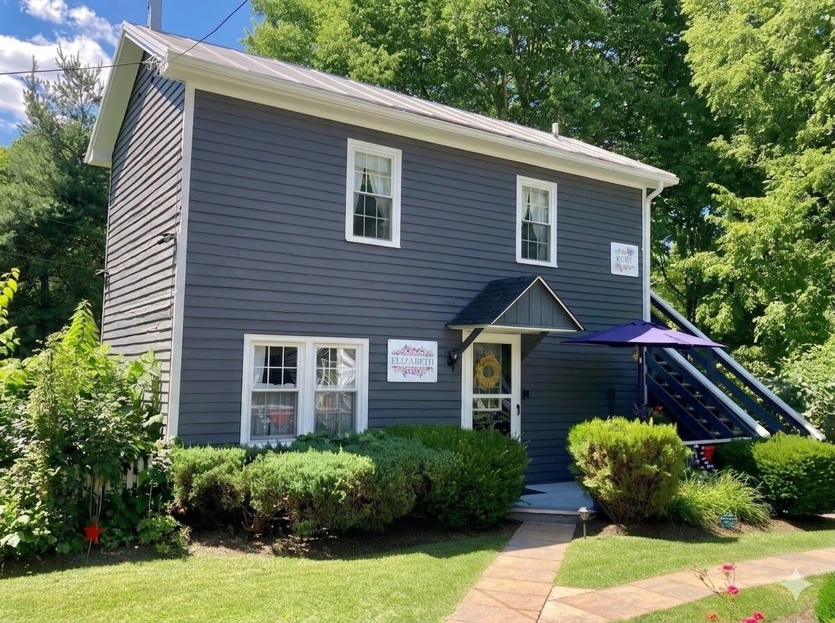 A two-story house with a front porch, a sign reading 'ELIZABETH,' and a small staircase leading to the entrance.