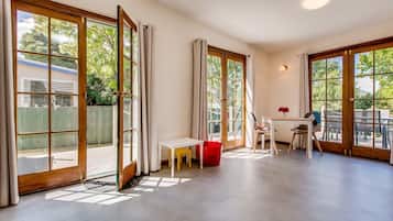 Deluxe House, 3 Bedrooms | Living room | Flat-screen TV