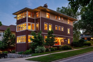 A two-story house with multiple windows and a well-maintained lawn. - The Buckingham Inn (Madison)