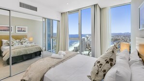 A modern hotel room with a large bed, a glass partition, and a city view. - 5*****Star Luxury 51 floors High (Surfers Paradise)