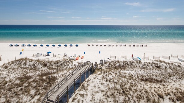 A beach with a wooden boardwalk leading to the shore, white sand, and a clear blue sky. - PI 501: Flip Flop Flats - Spectacular East 5th Floor Corner Unit Memory Maker (Fort Walton Beach)