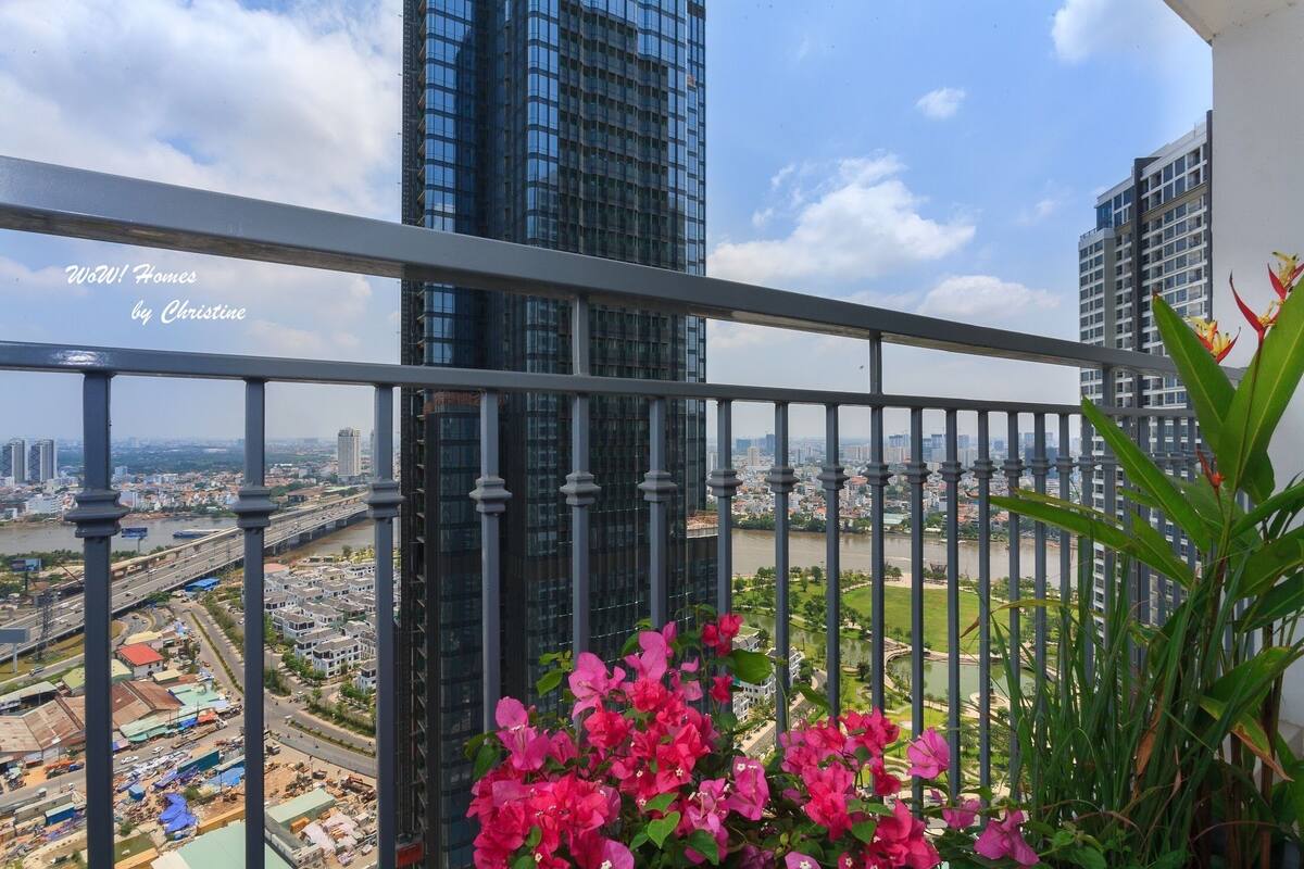 Ein Balkon mit Blick auf eine Stadtlandschaft, darunter hohe Gebäude und ein Fluss.
