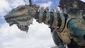 A large mechanical dragon with a detailed head and armor-like body, set against a cloudy sky. - STUDIO Appart gite Petite Halte,... work, vacation. (Wavrans sur l'aa)