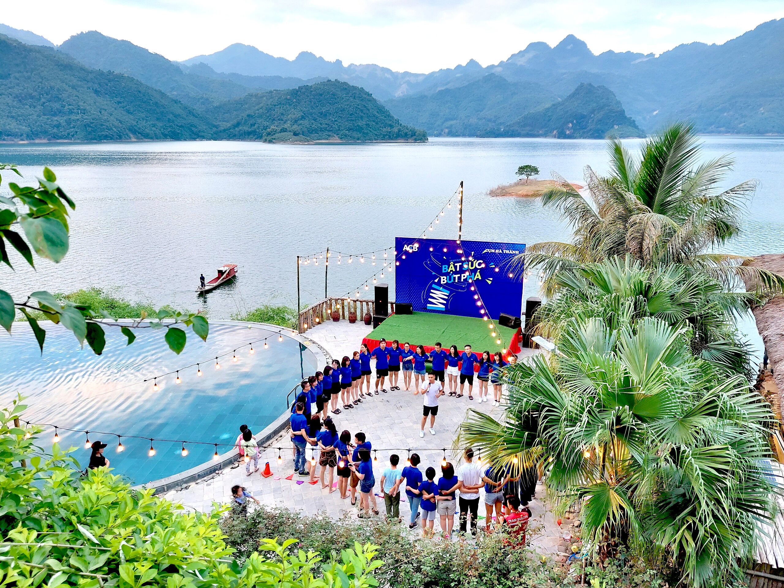 A stage with a blue backdrop and a group of people standing in front of it.