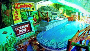 A pool area with a sign reading "Exclusive Pool for Exclusive Use." - Buena Lynne's Resort Annex (Puerto Galera)