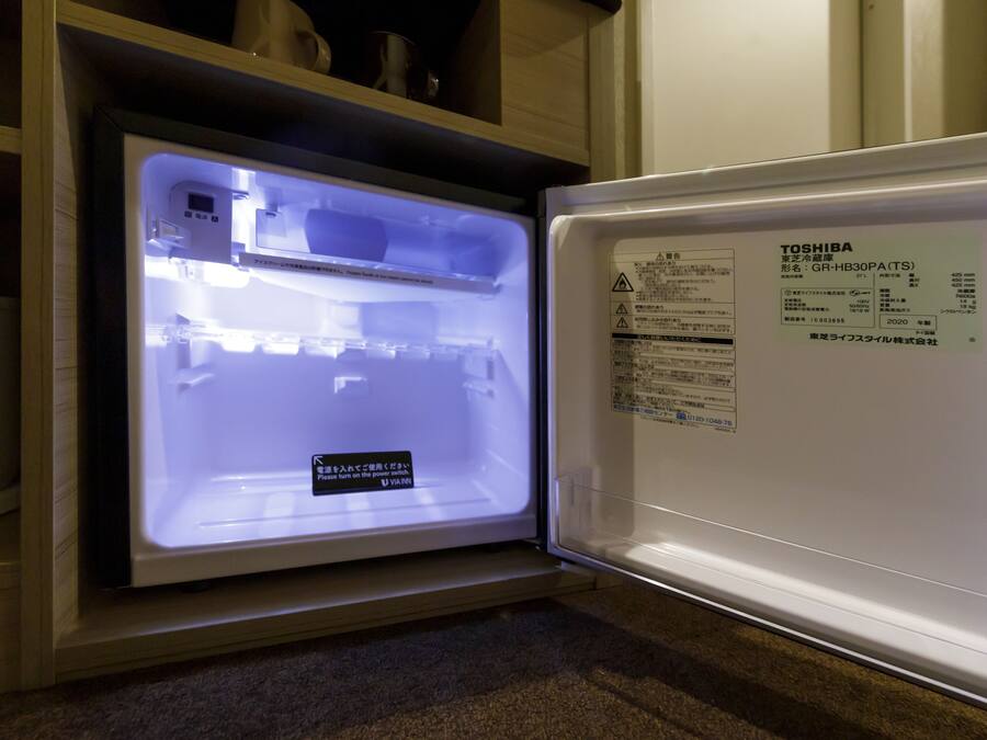 An open refrigerator with a label on the door.