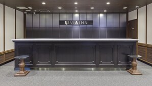 A reception desk with a dark wood finish, a marble top, and two wooden stools. - JR WEST GROUP VIA INN SHIMONOSEKI (Shimonoseki)