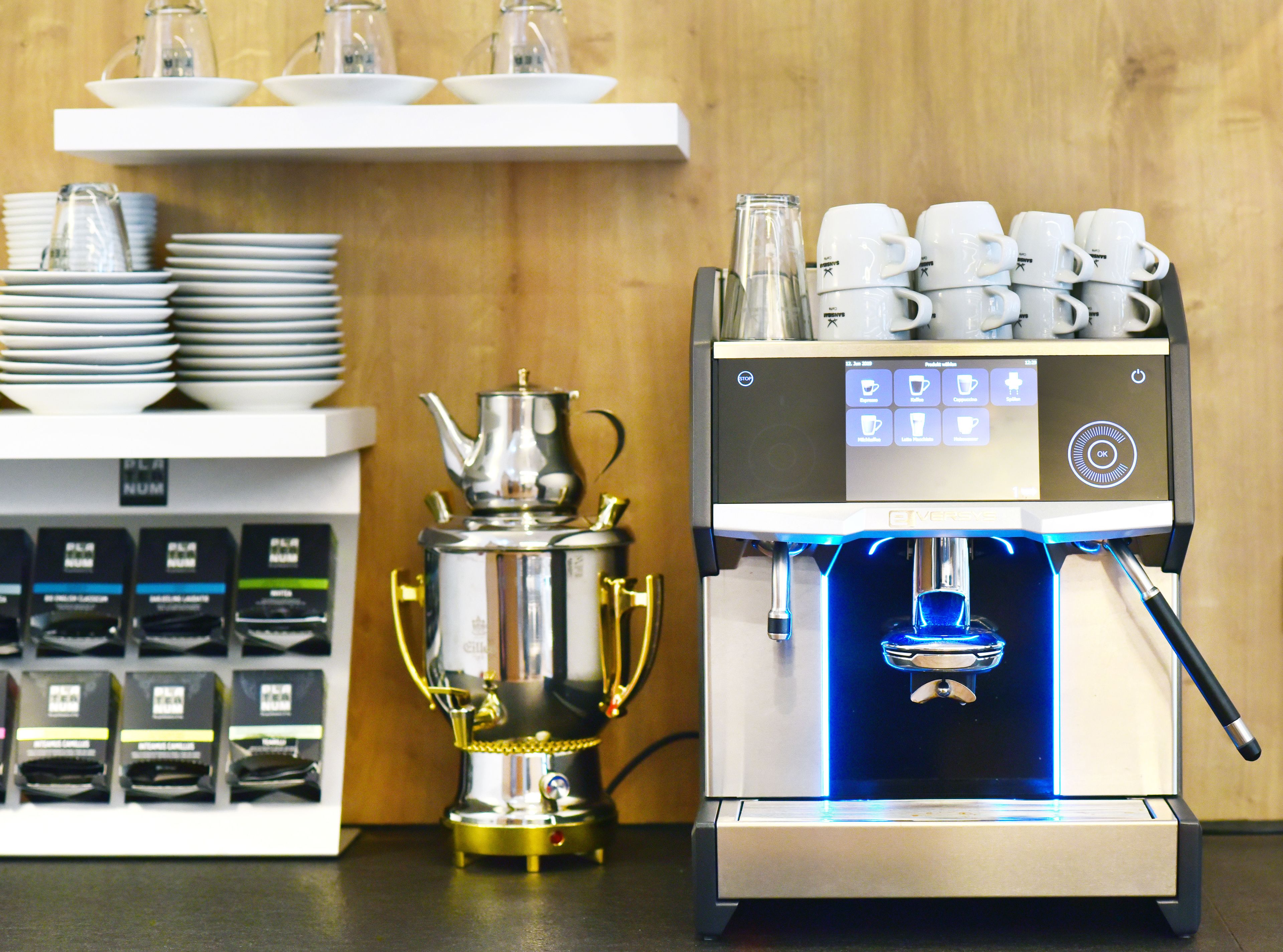 A coffee machine with a digital display and a coffee pot.
