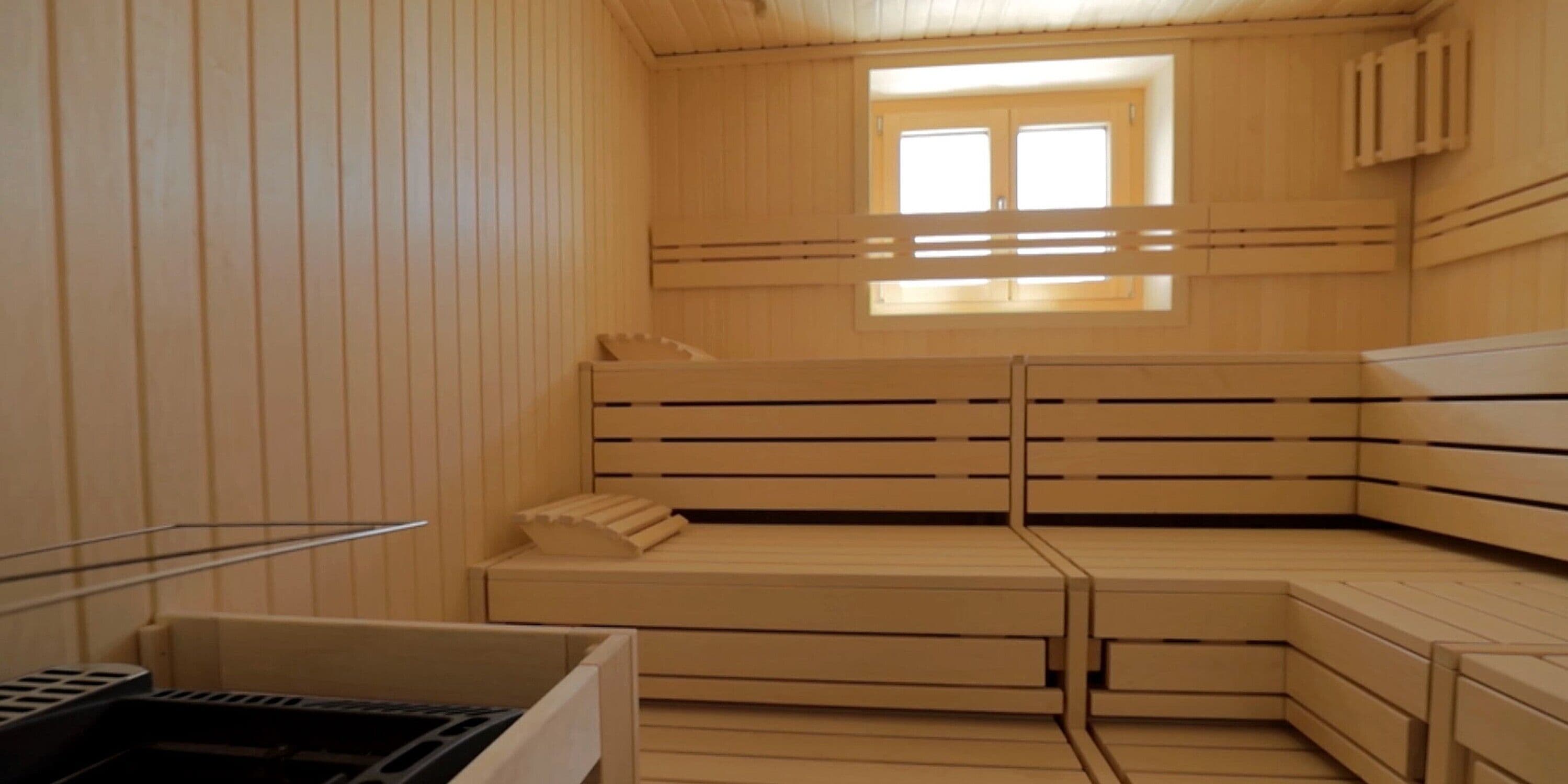 A sauna with wooden benches and a window.