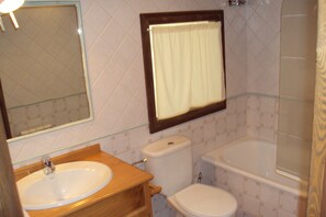 A bathroom with a sink, toilet, and bathtub.