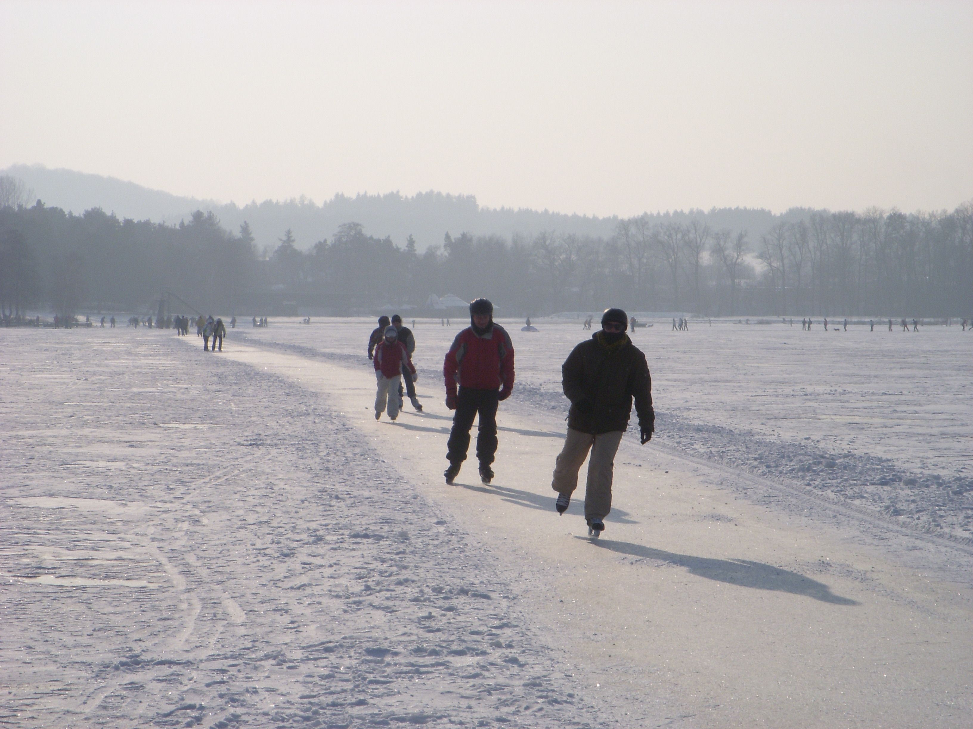 A snowy landscape with people walking.