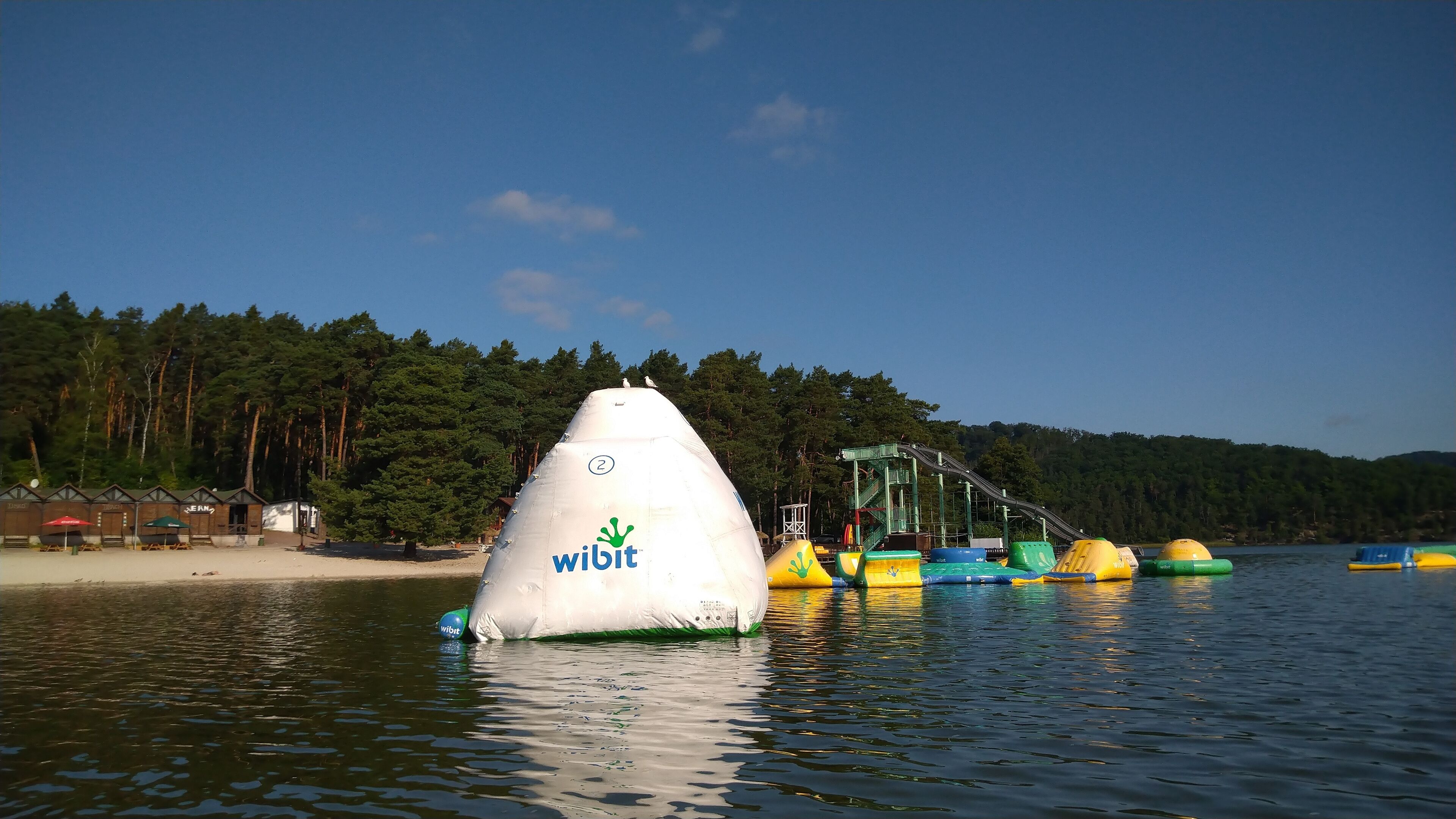 A water body with a large white buoy marked with the number 2 and the word "Wibit".