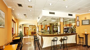 A hotel lobby with a bar area, seating, and a reception desk. - Hotel Anna (Cocentaina)