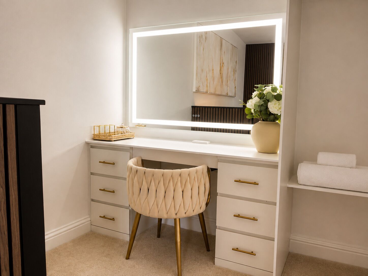 A bathroom with a vanity, mirror, and a stool.