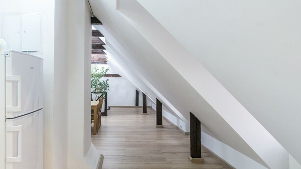 A spacious, modern kitchen with a wooden floor and white walls. - House 54 (Brasov)