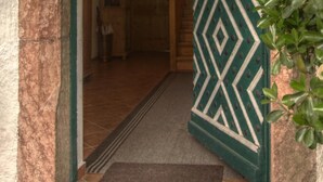 An arched doorway with a geometric-patterned door. - Alpenhof Punzenlehen (Schoenau am Koenigssee)