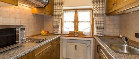 Fridge, coffee/tea maker, high chair, cookware/dishes/utensils