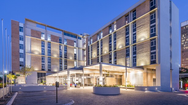 A modern hotel with a central courtyard, large windows, and a covered entrance area. - ONOMO Hotel Durban (Durban)