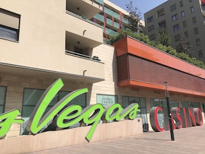 A building with large green and red signage reading "Vegas Casino." - Corvin Rose Apartment Hotel (Budapest)
