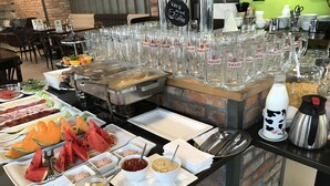 A buffet setup with various food items and drinks. - Corvin Rose Apartment Hotel (Budapest)