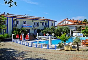 A building with a sign reading "Sugar Family Apart & Hotel". - Sugar Family Apart Hotel (Fethiye)