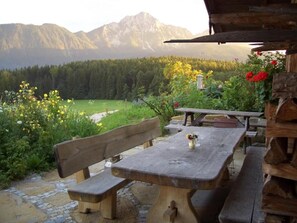 Sit and take in the breathtaking view of the surrounding mountains and forested valley from this outdoor seating area.