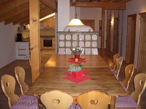 Enjoy meals with family and friends at this dining area, featuring a long table and six comfortable chairs.