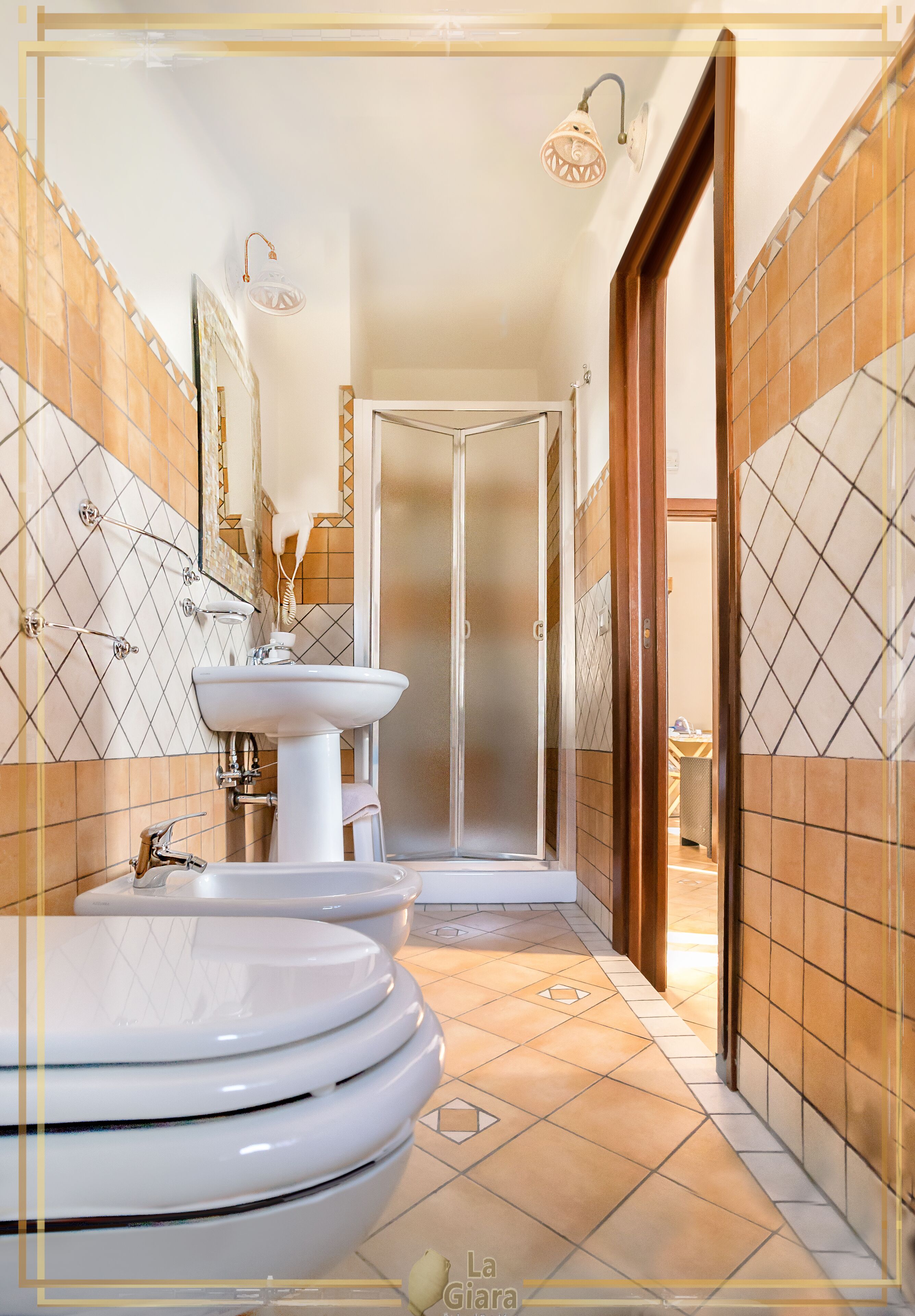 A bathroom with a white sink, two toilets, and a shower area.