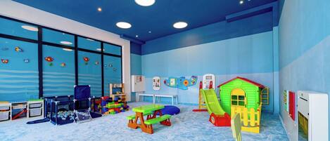 A children's play area with a slide, playhouse, and various toys.