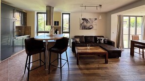 A modern living space with a kitchen, dining area, and seating area.