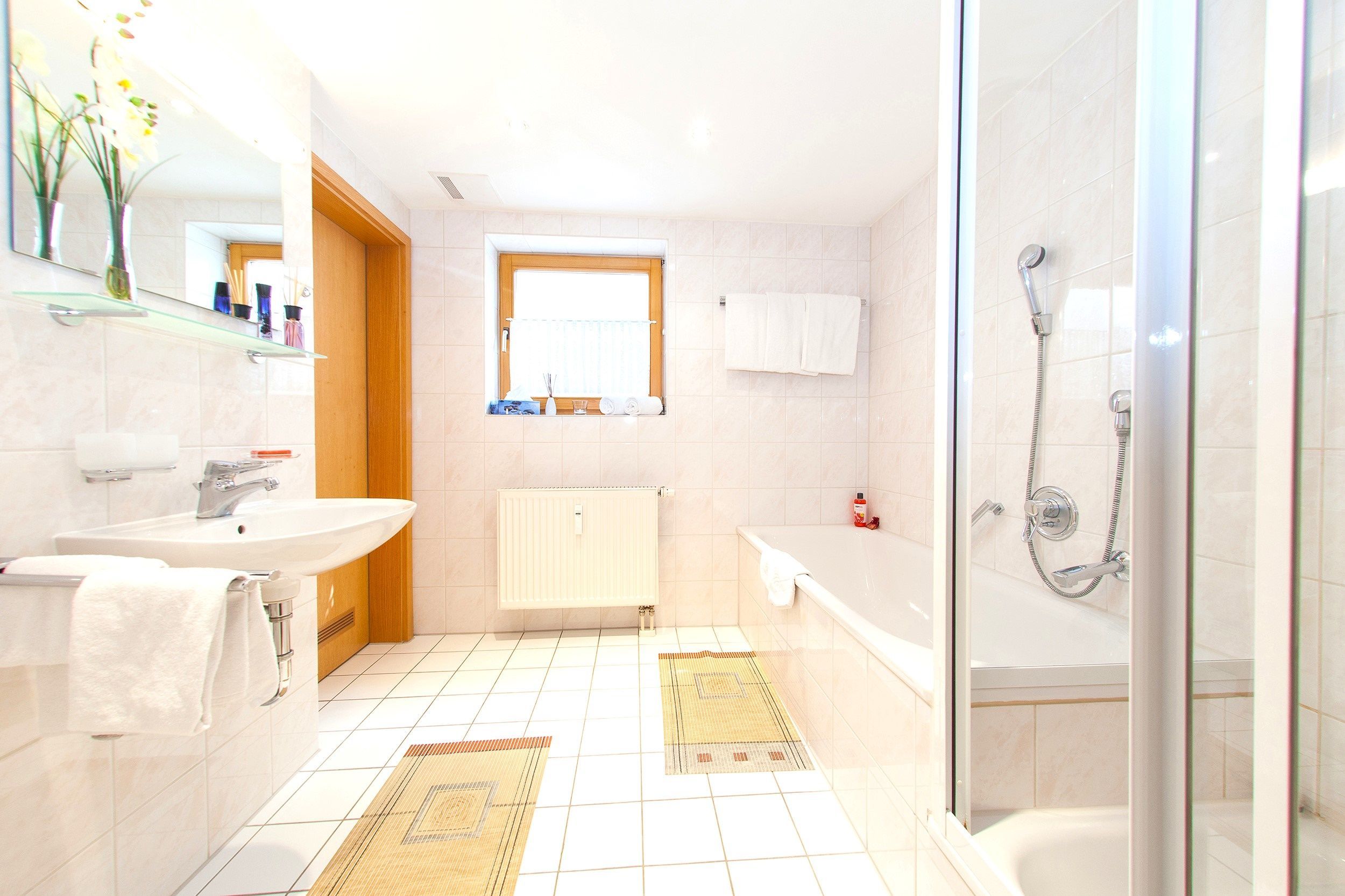A bathroom with a shower, sink, and toilet.