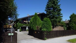 A building with a sign reading "Landhaus" and a gated entrance.