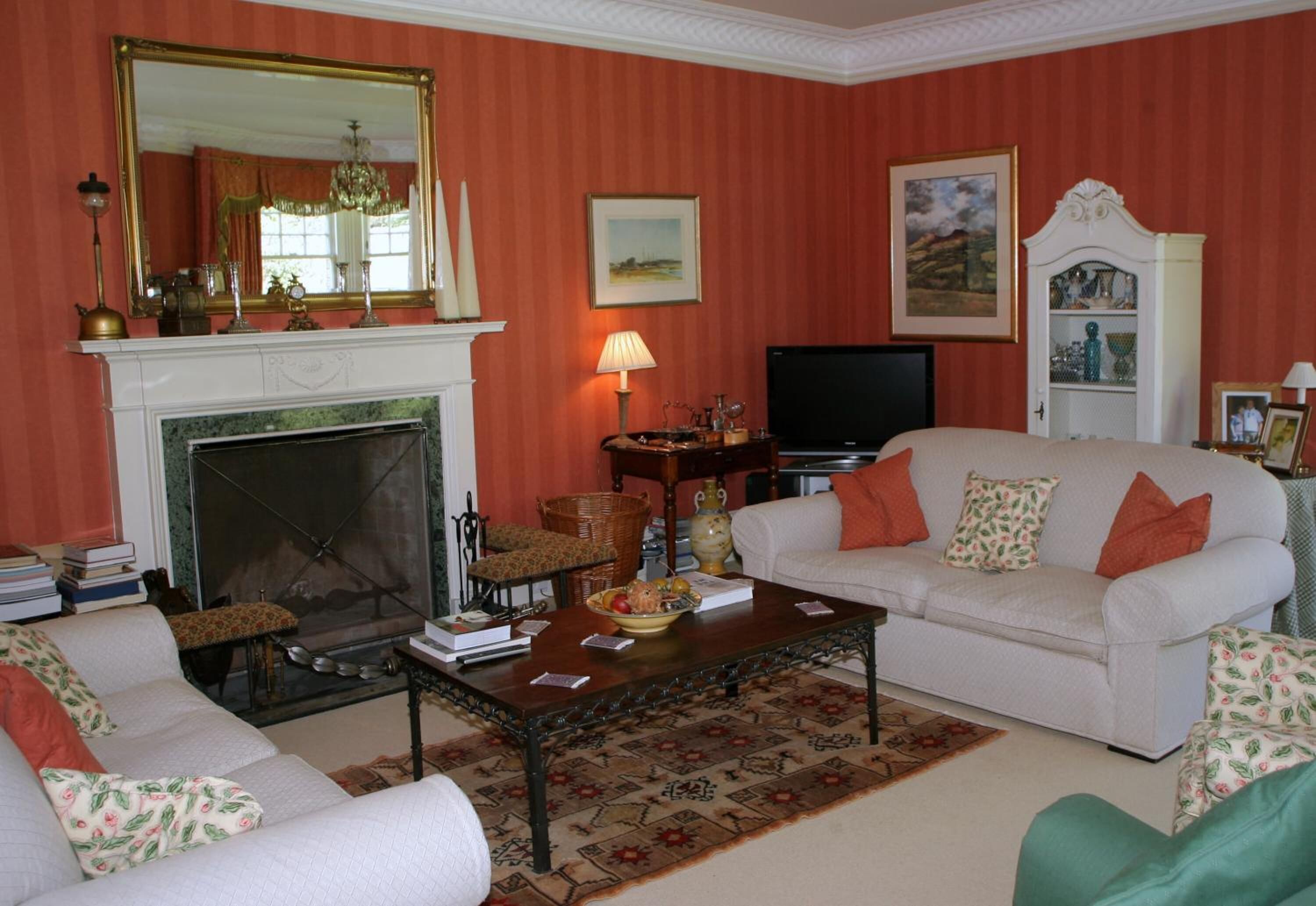 A living room with a fireplace, a television, and a sofa.