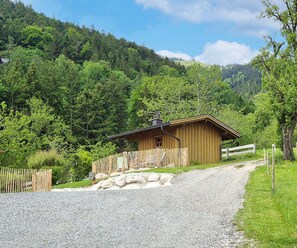 Guests can enjoy a peaceful retreat in this secluded cabin, surrounded by lush green hills.