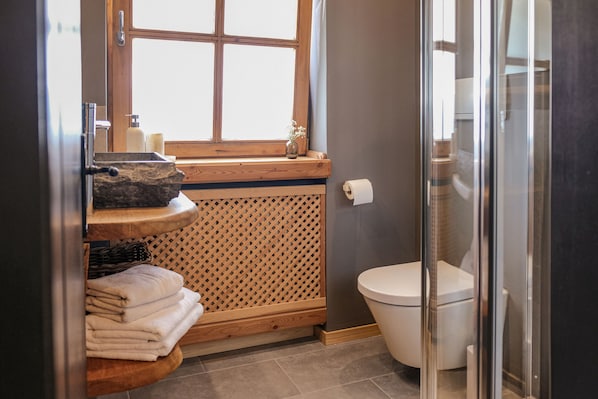 A bathroom with a wooden vanity, a toilet, and a glass shower enclosure. - (1) Ferienwohnung 1 mit eigenem Garten (Reit im Winkl)